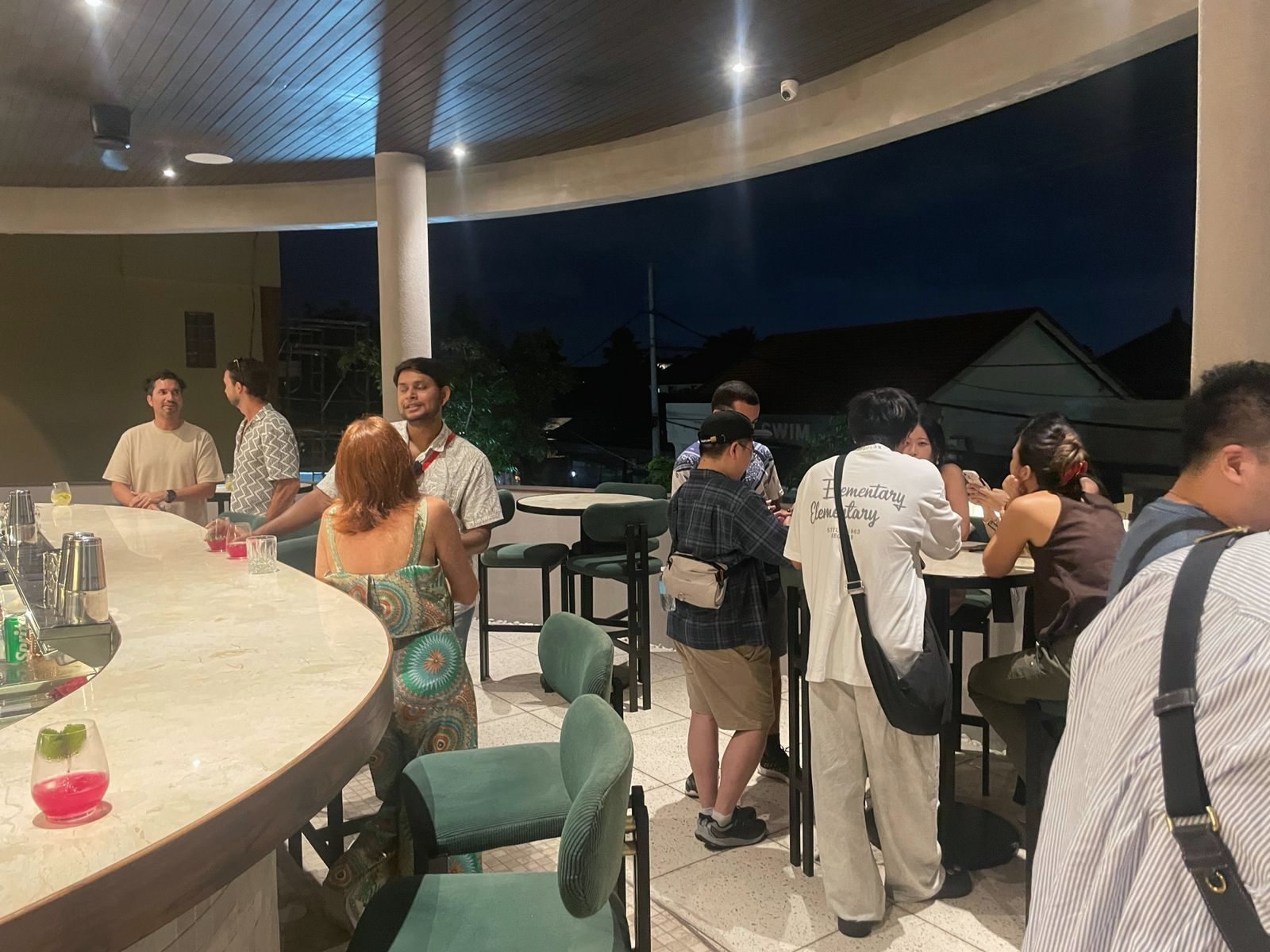 Founders and investors around the bar on the terrace at the Bali Founder × VC Happy Hour