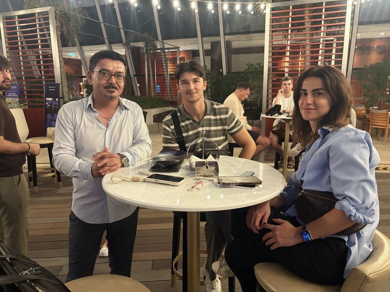Guests at a table on the terrace at the Dubai Founder × VC Happy Hour